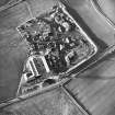 Oblique aerial view centred on the works and the remains of the field boundary, taken from the E.