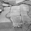 Oblique aerial view centred on the cropmarks of the Antonine Wall near Summerston Farm, taken from the S.