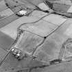 Oblique aerial view centred on the cropmarks of the Antonine Wall near Summerston Farm, taken from the SE.