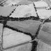 Oblique aerial view centred on the cropmarks of the Antonine Wall near Cadder, taken from the SE.