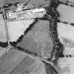 Oblique aerial view centred on the cropmarks of the Antonine Wall near Cadder, taken from the NE.