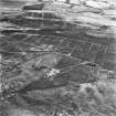 Avonhead Colliery, oblique aerial view, taken from the N, showing the spoil heaps of four coal mines and the remains of miners' rows in the centre of the photograph, an area of rig in the left centre and peat cuttings in the top half. Slamannan Railway runs across the top of the photograph, left to right.