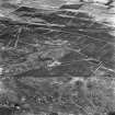 Avonhead Colliery, oblique aerial view, taken from the NNW, showing the spoil heaps of five coal mines and the remains of miners' rows in the centre of the photograph, an area of rig in the centre, and peat cuttings in the top half. Slamannan Railway runs across the top of the photograph, left to right.