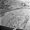 Mid Bracco, oblique aerial view, taken from the ENE, showing the remains of buildings, huts and enclosures in the centre right of the photograph, and field-systems at the top and bottom left-hand corner.