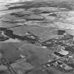 Hassockrigg Colliery and Easter Hassockrigg, oblique aerial view, taken from the W, showing the three bings at Hassockrigg Colliery, and Easter Hassockrigg open-cast mine, all in the centre of the photograph.