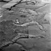 Bashaw and King's Law, oblique aerial view, taken from the NNW, showing the remains of enclosures on King's Law and a cairn, and the ruins of Bashaw farmstead and a quarry, in the top centre of the photograph. King's Law Limestone quarries, clamp kilns and an area of rig are visible in the bottom half.