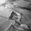 Oblique aerial view centred on the remains of the quarry, taken from the SW.