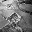 Oblique aerial view centred on the remains of the quarry, taken from the SW.