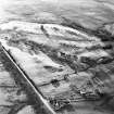 Oblique aerial view centred on the remains of rig, taken from the ENE.