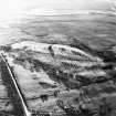 Oblique aerial view centred on the remains of rig, taken from the NE.