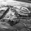 Oblique aerial view centred on the remains of rig, taken from the NNE.