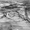 Oblique aerial view centred on the remains of rig with town of Lesmahagow adjacent, taken from the SW.