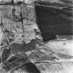 Salterhill, Drumclair and Airdriemain, oblique aerial view, taken from the NNW, showing Salterhill coal mine and an adjoining railway in the bottom of the photograph, the faint remains of miners' rows at Drumclair in the centre left, and an area of rig at Airdriemain along the bottom.