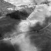 Oblique aerial view centred on the cropmarks of the fort with palisaded settlement adjacent, taken from the WSW.