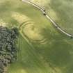 Oblique aerial view centred on the cropmarks of the fort, taken from the NNW.