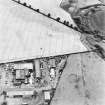 Johnstone Haugh, oblique aerial view, taken from the E, centred on a settlement and rig. The Samye-Ling Tibetan Buddhist Centre is visible in the bottom half of the photograph.