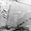 Oblique aerial view centred on the cropmarks of the pits, rig and Roman temporary camps, taken from the WNW.