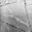 Oblique aerial view centred on the cropmarks of the pits, rig and Roman temporary camps, taken from the WSW.
