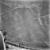 Oblique aerial view of Wester Carmuirs centred on a Roman temporary camp with another possible temporary camp and ring-ditch adjacent, taken from the ESE.
