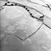 Oblique aerial view centred on the cropmarks of the Roman temporary camp, taken from the SSE.