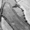 Oblique aerial view centred on the cropmarks of the E ring-ditch, taken from the NW.