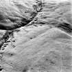 Oblique aerial photograph of shieling-huts and bank on west bank of the Second Inchna Burn (NS89NE 109) with head-dyke of neighbouring field-systems (NS89NW 54.02 and NS89NE 56.03) in background, from north-east.