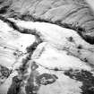 Oblique aerial view of Loss Burn centred on the remains of a farmstead, park and rig with an archaeological landscape adjacent, taken from the NNW.