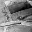 Oblique aerial view centred on the soilmarks of the Roman fortlet, taken from the NW.