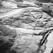 Oblique aerial view centred on the remains of rig with cairn adjacent, taken from the NE.