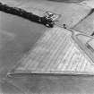 Castledykes Roman Temporary Camp, oblique aerial view, taken from the ENE, centred on the cropmarks of NE corner of the camp.