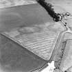 Castledykes Roman Temporary Camps, oblique aerial view, taken from the NE, centred on the cropmarks of a camp, which is also visible, with another camp, at the top edge of the photograph.