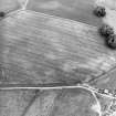 Oblique aerial view centred on the cropmarks of the Roman temporary camp and field-system, taken from the WSW.