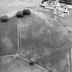 Oblique aerial view centred on the cropmarks of the Roman temporary camp and field-system, taken from the N.