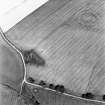 Craigie Burn, oblique aerial view, taken from the SW, centred on the cropmarks of a settlement and field boundaries. A possible henge monument is visible in the top right-hand corner of the photograph.