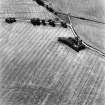 Craigie Burn, oblique aerial view, taken from the ENE, centred on the cropmarks of a settlement and field boundaries. A henge is visible in the bottom left-hand corner of the photograph.