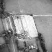 Oblique aerial view centred on the cropmarks of the possible enclosure with country house, dovecot and stable adjacent, taken from the W.