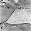 Skirling Mains, oblique aerial view, taken from the W, centred on the cropmarks of a possible settlement and an enclosure.