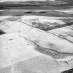 Morton Hill, oblique aerial view, taken from the N, showing an area of rig and furrow cultivation across the photograph, a sheepfold in the left centre, and a sheep shelter in the bottom right-hand corner.
