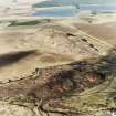 Tarbrax and Viewfield shale-oil works, oblique aerial view, taken from the SSE, showing Tarbrax shale-oil mine's large spoil heaps across the centre of the photograph, situated between a tramway, and the Tarbrax branch of the Caledonian Railway. Viewfield shale pit is visible in the top half.