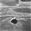 Cobbinshaw, oblique aerial view, taken from the SW, showing a section of the Tarbrax Branch of the Caledonian Railway running across the centre of the photograph, passing between South Cobbinshaw coal mine in the centre right, and brick works in the bottom half.