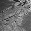 Cobbinshaw, oblique aerial view, taken from the NE, showing the Tarbrax Branch of the Caledonian Railway running from top to bottom across the photograph, between South Cobbinshaw coal mine and flooded brick works in the top right-hand corner of the photograph.