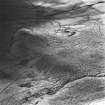 Tarbrax Shale-Oil Works, oblique aerial view, taken from the NE, showing the remains of the shale-oil mine and a tramway leading up to it in the centre and bottom left-hand corner of the photograph.