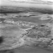 Tarbrax Shale-Oil Works, oblique aerial view, taken from the SSW, showing both massive shale bing of the shale-oil mine in the centre of the photograph, with a tramway running out from between them toward the bottom left-hand corner.