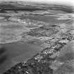 Tarbrax Shale-Oil Works, oblique aerial view, taken from the SSE, showing Tarbrax village in the foreground, and the massive bings and tramways of the shale-oil mine in the centre of the photograph. Two area of rig, Greenfield Burn, and Lawhead, are visible in the bottom left-hand and right-hand corners respectively. Tarbrax Church is amongst a group of buildings in the left centre.