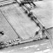 Merryless, oblique aerial view, taken from the NE, centred on cropmarks of parts of the military camp. The last remaining building is visible in the bottom left-hand corner of the photograph.