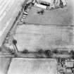 Merryless, oblique aerial view, taken from the W, centred on cropmarks of parts of the military camp. The last remaining building is visible in the top centre of the photograph.