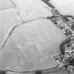 Oblique aerial view of Muirhouses centred on the cropmarks of a Roman temporary camp, taken from the SW.