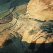 Oblique aerial view centred on the remains of the buildings, rig and cultivation terraces with the remains of the possible settlement, farmstead, homestead, enclosure and sheep shelter adjacent, taken from the SSE.