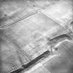 Oblique aerial view, taken from the N, centred on the cropmark of an enclosure.