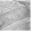 Oblique aerial view, taken from the N, centred on the cropmarks of a fort.